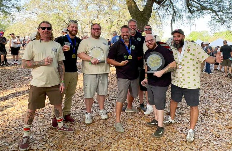 A group of men posing for a picture in a park.